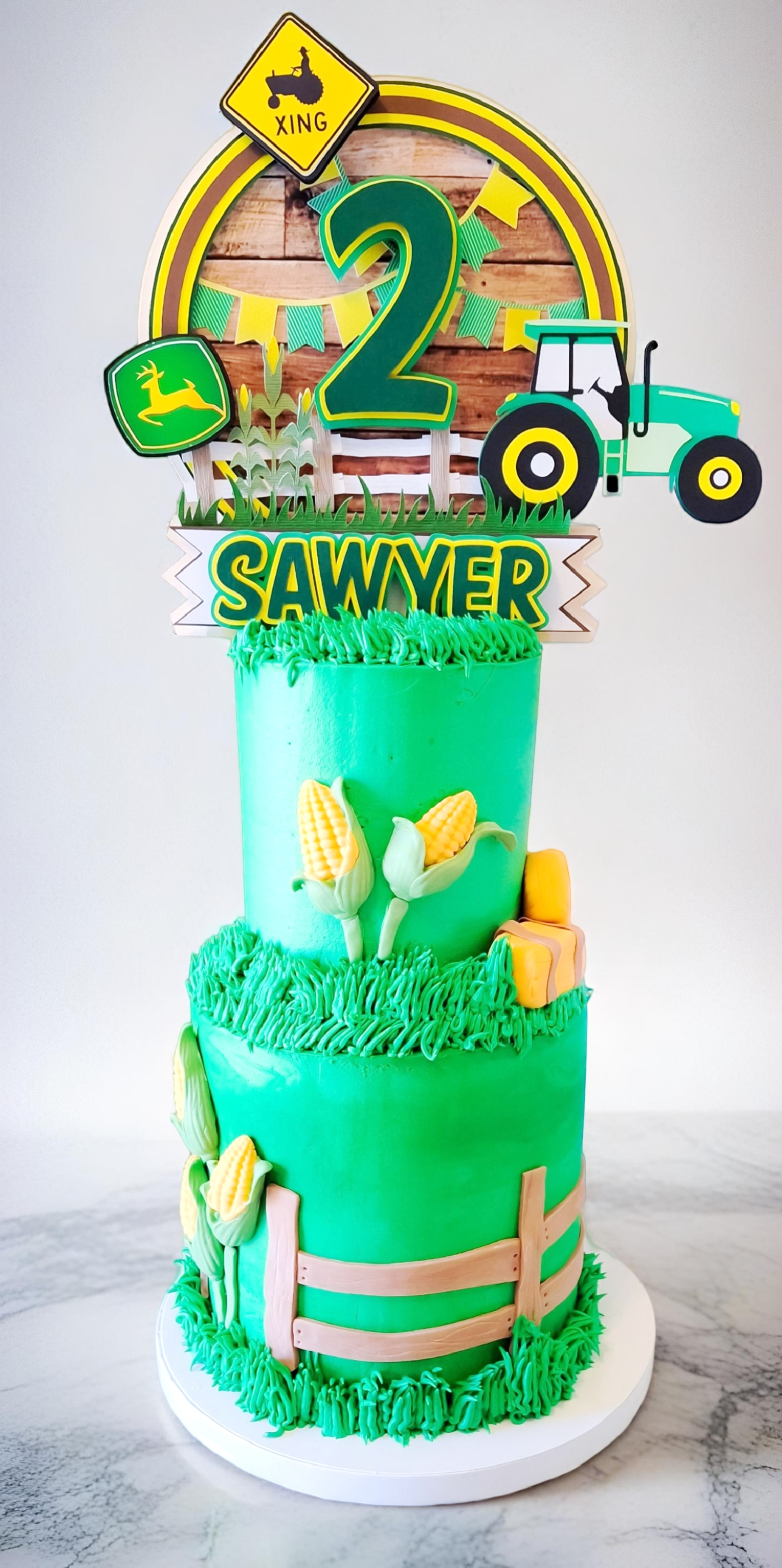 Two-tiered John Deere tractor themed birthday cake for a 2nd birthday
