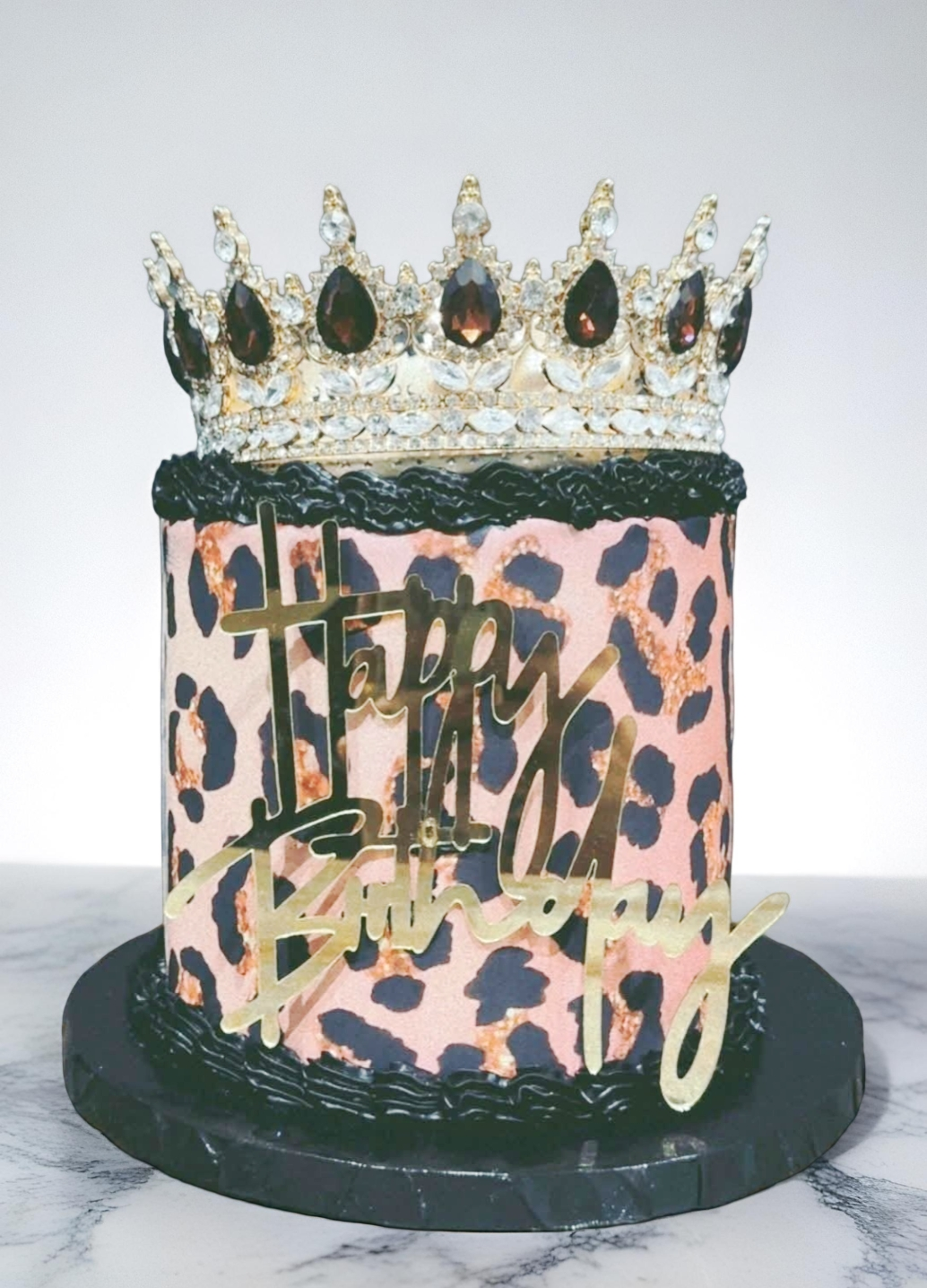 Decorative birthday cake with crown topper