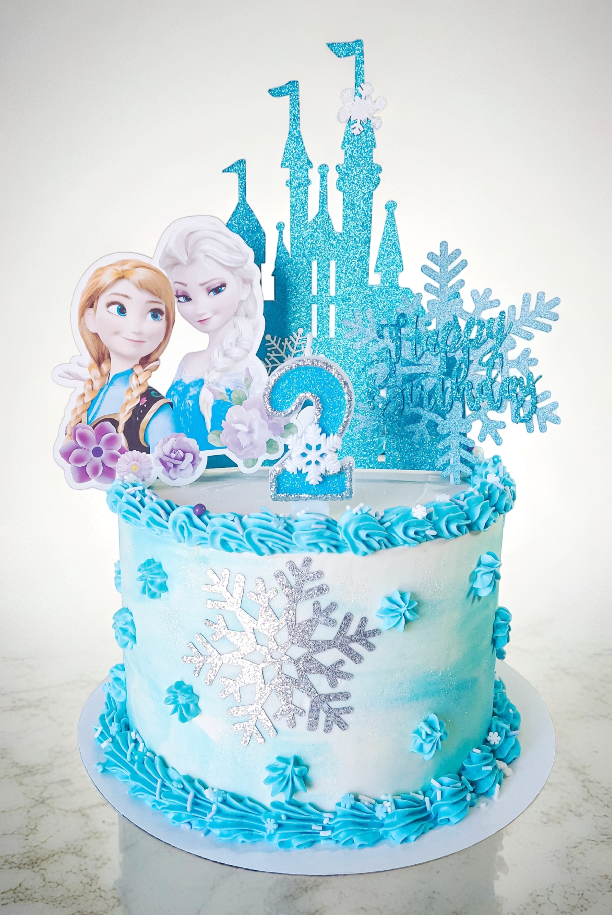 Frozen themed birthday cake with castle topper