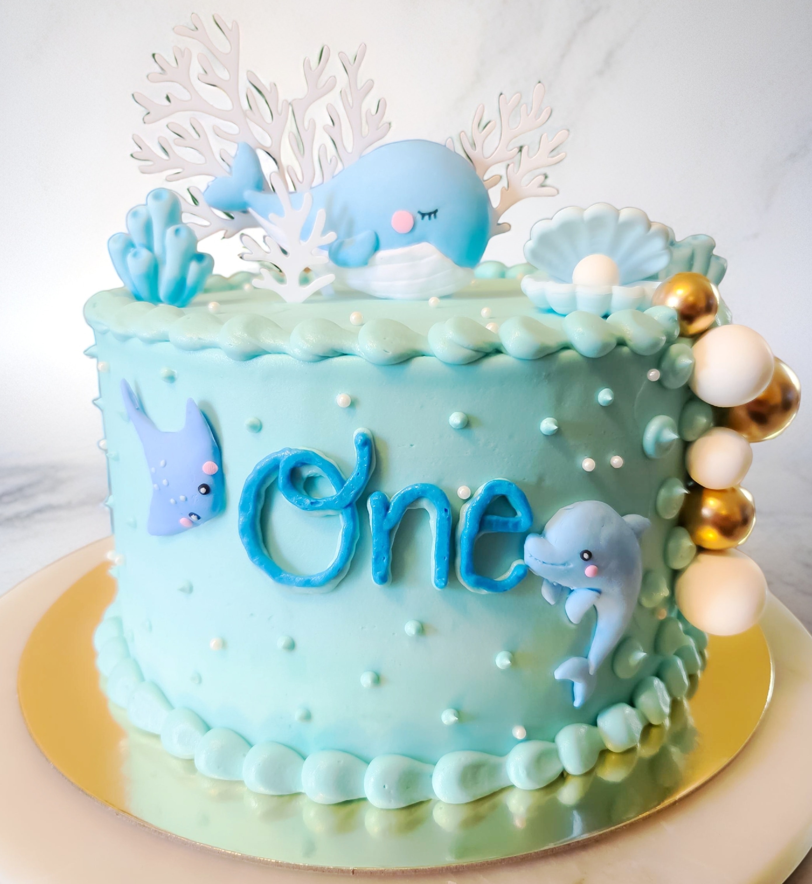 Whimsical ocean themed birthday cake with whale